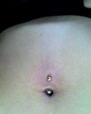 The pen ink was smeared when the piercer tried to screw the ball on, which is why there's purple gunk everywhere.